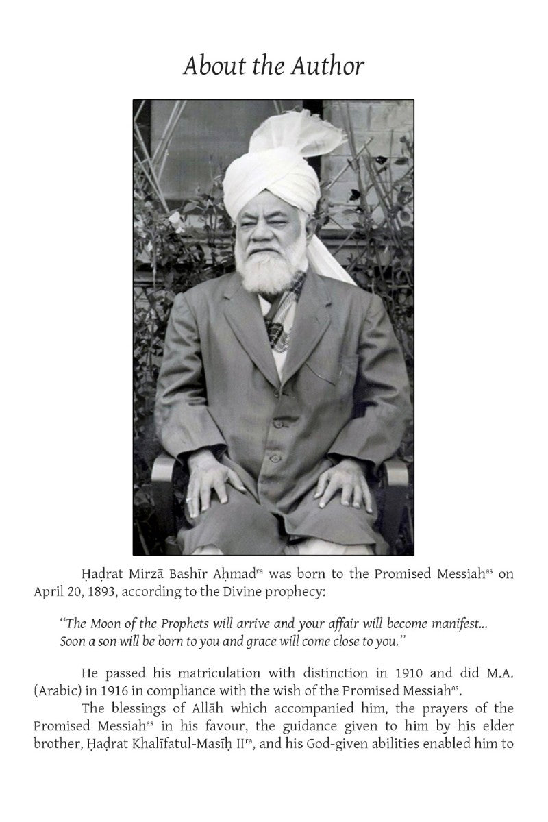 Black and white photo of a man with a turban and beard, sitting outdoors.