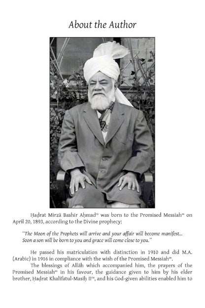 Black and white photo of a man with a turban and beard, sitting outdoors.