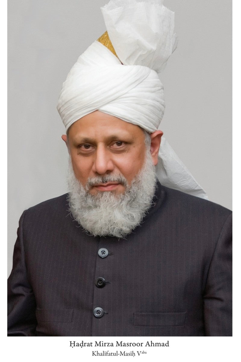Man wearing a white turban and dark suit against a gray background